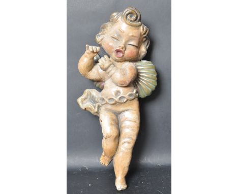 20th century Architectural painted composite figure of a winged cherub - putti. Faux wood being hollow cast and painted. Hook