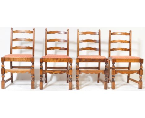 A set of four mid 20th century dark wood dining chairs / pub chairs. The chairs having a ladder backrests, drop in seats rais