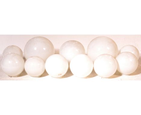 A group of 10 graduated vintage retro 20th century lamp / light shade. The glass light shades of a spherical form with white 
