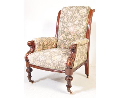 A good Victorian 19th century mahogany framed salon / library armchair. The chair being raised on good turned legs with casto