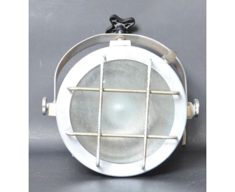 A 21st-century vintage style spotlight / lamp. The lamp having a cylindrical metal body with wired cage protection to the fro