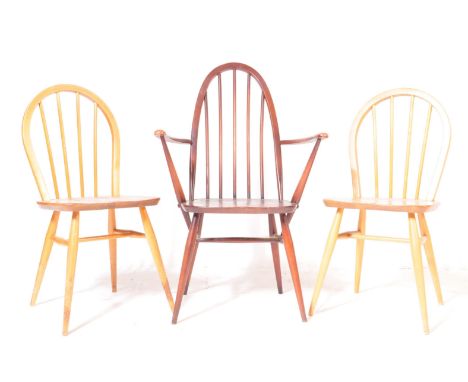 Ercol - British Modern Design - A pair of light beech and elm Windsor ding chairs having hoop backs, saddle seats raised on t