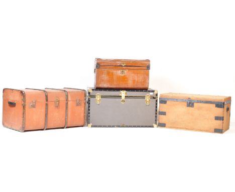A group of four mid 20th century trunks / shipping trunks. The collection includes a wooden banded shipping trunk, metal mili