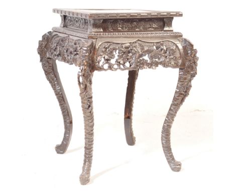 An early 20th century carved hardwood Chinese side&nbsp; / lamp table. Raised on shaped legs with hoof feet having carved and