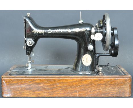 A vintage 20th century manual cased Singer sewing machine having an ebonised black body with gilt detailing. Serial number Y5