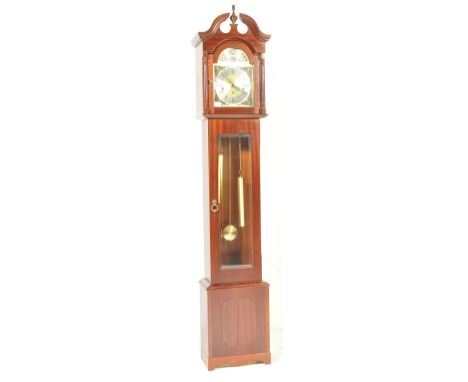 A 20th century mahogany veneer cased Tempus Fugit Longcase granddaughter clock. The upright case with decorative hood housing