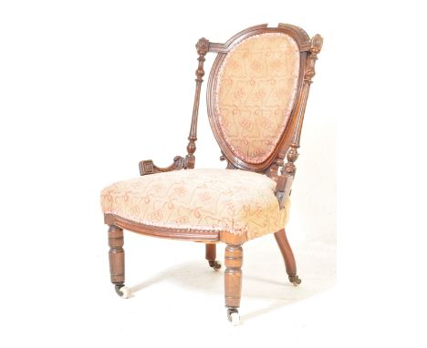 A 19th century Victorian mahogany boudoir chair of highly decorative form. Raised on white ceramic castors with turned legs, 