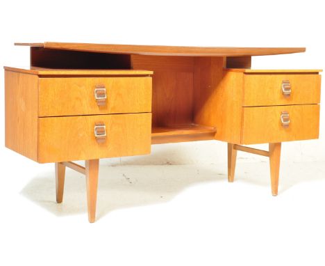 A retro vintage mid 20th century teak veneer desk having a single floating shelf above a central kneehole flanked by banks of