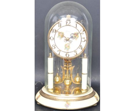 A vintage 20th century Kern &amp; Sohne anniversary clock having a white enamel and polychrome florally decorated clock face 
