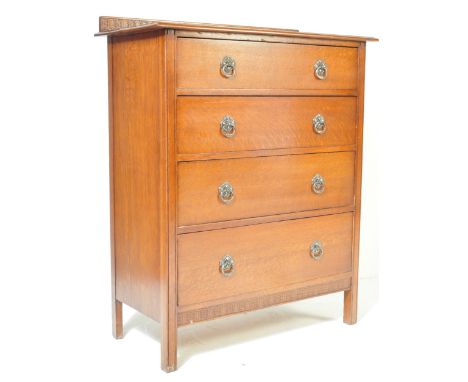 A 1920's oak chest of drawers. Raised on squared legs having an upright bank of drawers. Each drawer with drop ring handles o