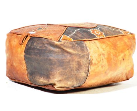 A vintage 20th century leather and snakeskin patchwork pouffe / floor cushion having geometric patterns to the centre and fol