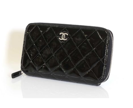 A Chanel black patent zip around wallet,silver tone CC logo to front, interior with card sections and zip pocket, serial numb