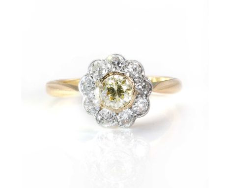 A coloured diamond flowerhead cluster ring, the round brilliant cut light yellow diamond, estimated weight 0.45ct, in a yello