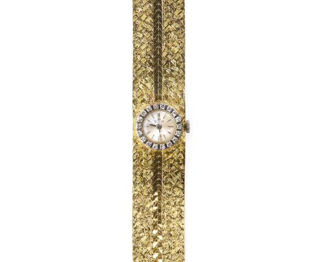 A ladies' 18ct yellow and white gold, diamond set Bucherer mechanical cocktail watch, c.1985, a circular silvered dial with s