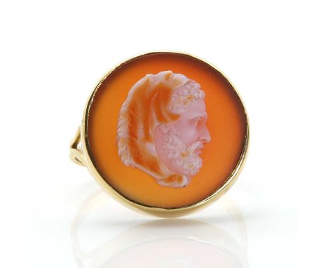 A circular hardstone cameo ring,  depicting Hercules wearing a lion pelt cloak, rub set to a plain shallow collet, split shou