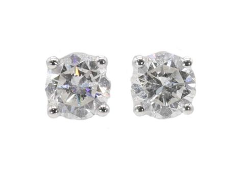 A pair of single stone diamond stud earrings, with a stated total diamond weight of 1.20ct. Each brilliant cut diamond with a