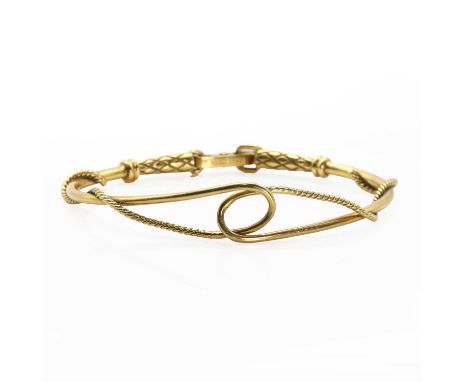 An 18ct gold rope design articulated bangle, by Gucci, modelled as entwined polished and twisted ropes, with grooved ends. A 