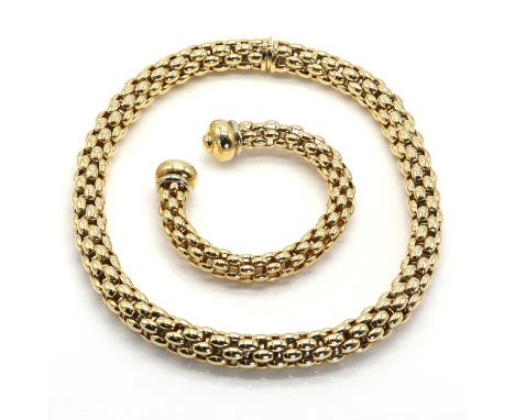 An 18ct two colour gold necklace and torque bangle matched 'Flex-it Diva' suite, by Fope c.1990,The circular section necklace