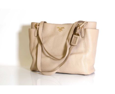 A Prada cream leather tote,dual flat handles, gold one hardware, exterior pocket to each side, magnetic closure, interior wit