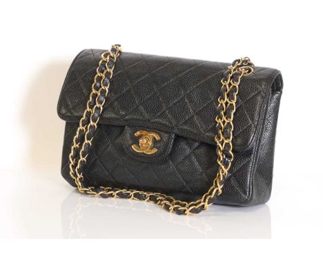 A Chanel black grained leather flap bag, gold tone hardware, opening to interior pockets, serial number 6309547, with authent