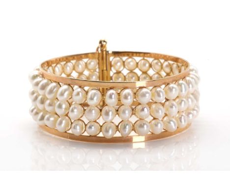 A gold mounted three row cultured freshwater pearl bangle,the pierced bangle with three rows of cultured freshwater pearls, u