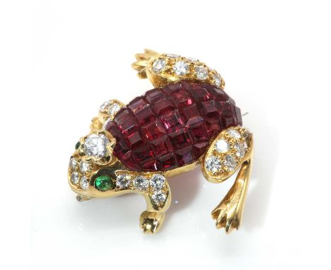 A ruby, emerald and diamond frog brooch,with rows of calibré cut rubies, invisibly set to the back. A brilliant cut diamond c