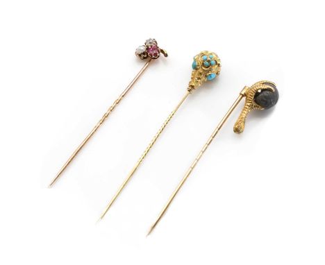 A cased Victorian gold stick pin, in the form of a talon or claw with scale decoration, holding a cast lead ball, possibly a 