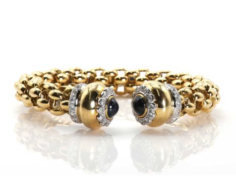 An Italian gold sapphire and diamond set flexible torque bangle,the flexible open cuff with gold links and an enclosed steel 