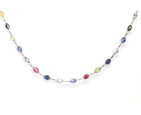 A multicolour sapphire and ruby long chain necklace,spectacle set along the whole length with oval cut rubies and blue, green