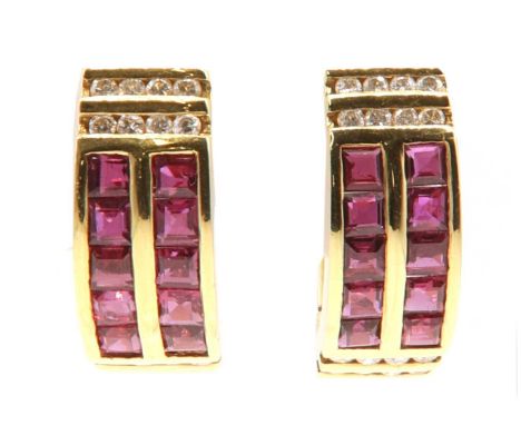 A pair of Continental ruby and diamond cuff style hinged hoop earrings,with two rows of calibré cut channel set rubies. Two r