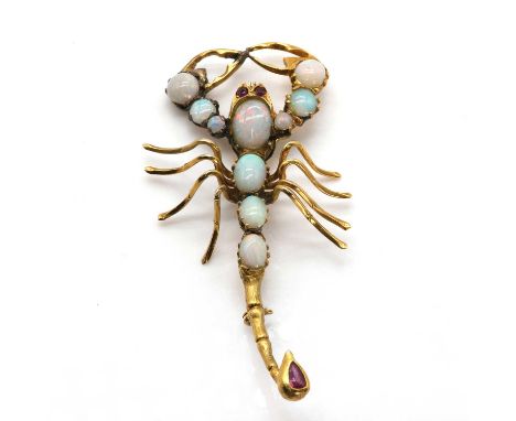 A gold, opal and ruby scorpion brooch,with ruby set eyes. Each pincher comprising a line of graduated circular cabochon opals