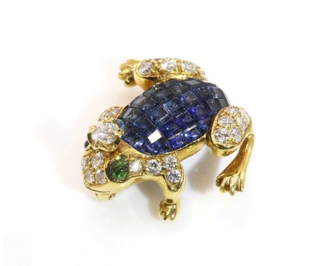 A sapphire, emerald and diamond frog brooch,with rows of calibré cut sapphires, invisibly set to the back. A brilliant cut di