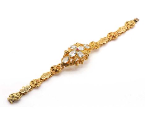 A Victorian aquamarine and ruby bracelet,the central feature a cruciform of oval cut aquamarines around a small cushion cut r
