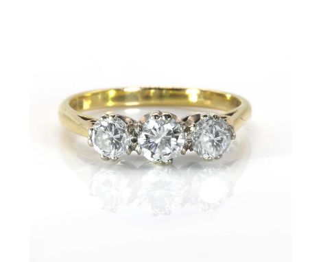 An 18ct gold three stone diamond ring,  with three slightly graduated brilliant cut diamonds, all double claw set in white co