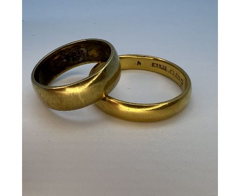 Two yellow gold band rings. Comprising a 22ct yellow gold band ring, size R, approximate weight 5.2 grams; and an 18ct gold b