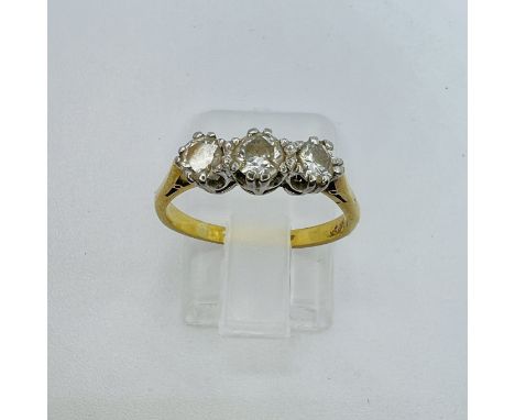 A diamond trilogy ring with an estimated total carat weight of 0.55 carats across all three stones. The central stone is an e