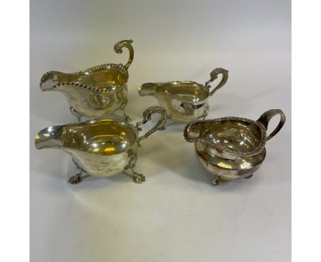 A group of three sterling silver sauce boats and a sterling silver creamer. Comprising a Victorian ball footed creamer, with 