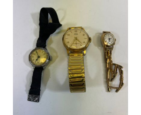 A 9ct yellow gold ladies manual wind wristwatch on a sprung 9ct strap.&nbsp; Approximately 13.4 grams.&nbsp; Two other watche