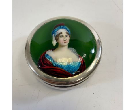 A silver lidded pot with a ladies portrait top. Approximately 8cm wide and 3.5cm tall. Approximate weight 82 grams. In genera