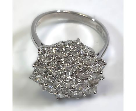 A handmade 18ct white gold diamond cluster ring, featuring a cluster of 19 0.15 carat (estimated) round brilliant cut diamond