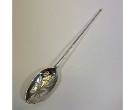 An 18th century sterling silver mote skimmer spoon. Featuring a scrollwork pattern pierced rat tail bowl, for skimming tea le