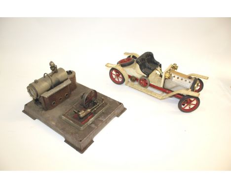 MODEL STEAM ENGINE a model steam engine on a metal base, also with a Mamod Steam Roadster Car. Engine Base 30cms by 24cms. (2