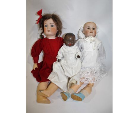 BISQUE HEAD DOLLS a small black Heubach Koppelsdorf doll with weighted brown eyes and closed mouth, also with a Cuno, Otto Dr