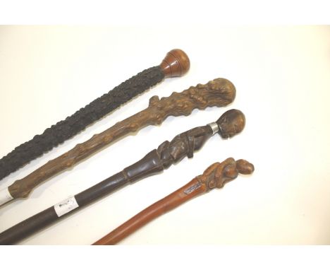 TRIBAL & OTHER WALKING STICKS including a bamboo walking stick carved with an animal and human figure, a root carved walking 