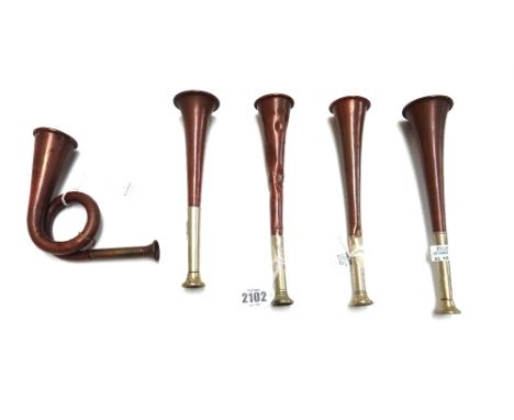 A copper hunting horn by 'Swaine & Adeney', another similar with indistinct stamped marks, two hunting horns stamped 'Made In