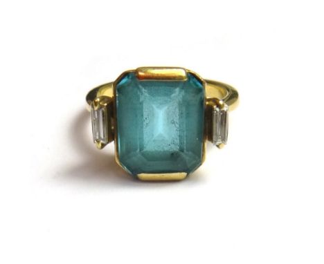 A gold, aquamarine and diamond set three stone ring, mounted with the cut cornered rectangular step cut aquamarine at the cen