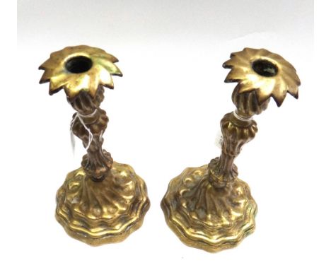 A pair of patinated bronze candlesticks, 19th century with spiral fluted bodies and shaped feet, 23cm high (2).