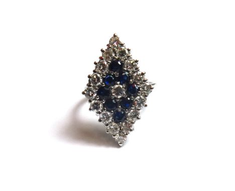 An 18ct white gold, diamond and sapphire set, marquise shaped cluster ring, mounted with a circular cut diamond at the centre