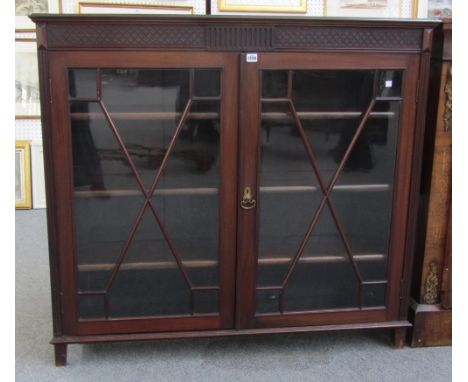 An early 20th century mahogany straight front display cabinet with astragal glazed doors on bracket feet, 122cm wide. 