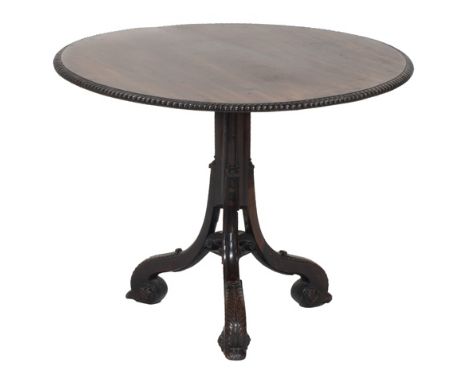 A George II and later carved mahogany tripod table, the gadrooned circular top on cluster column support united by scrolling 